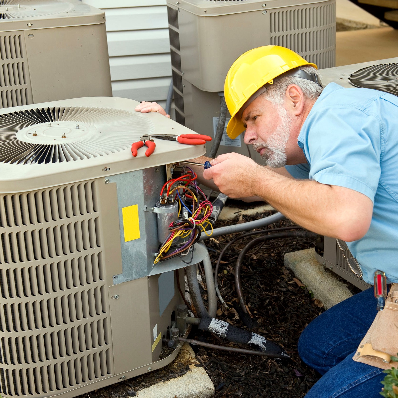 A technician working on an air conditioner.