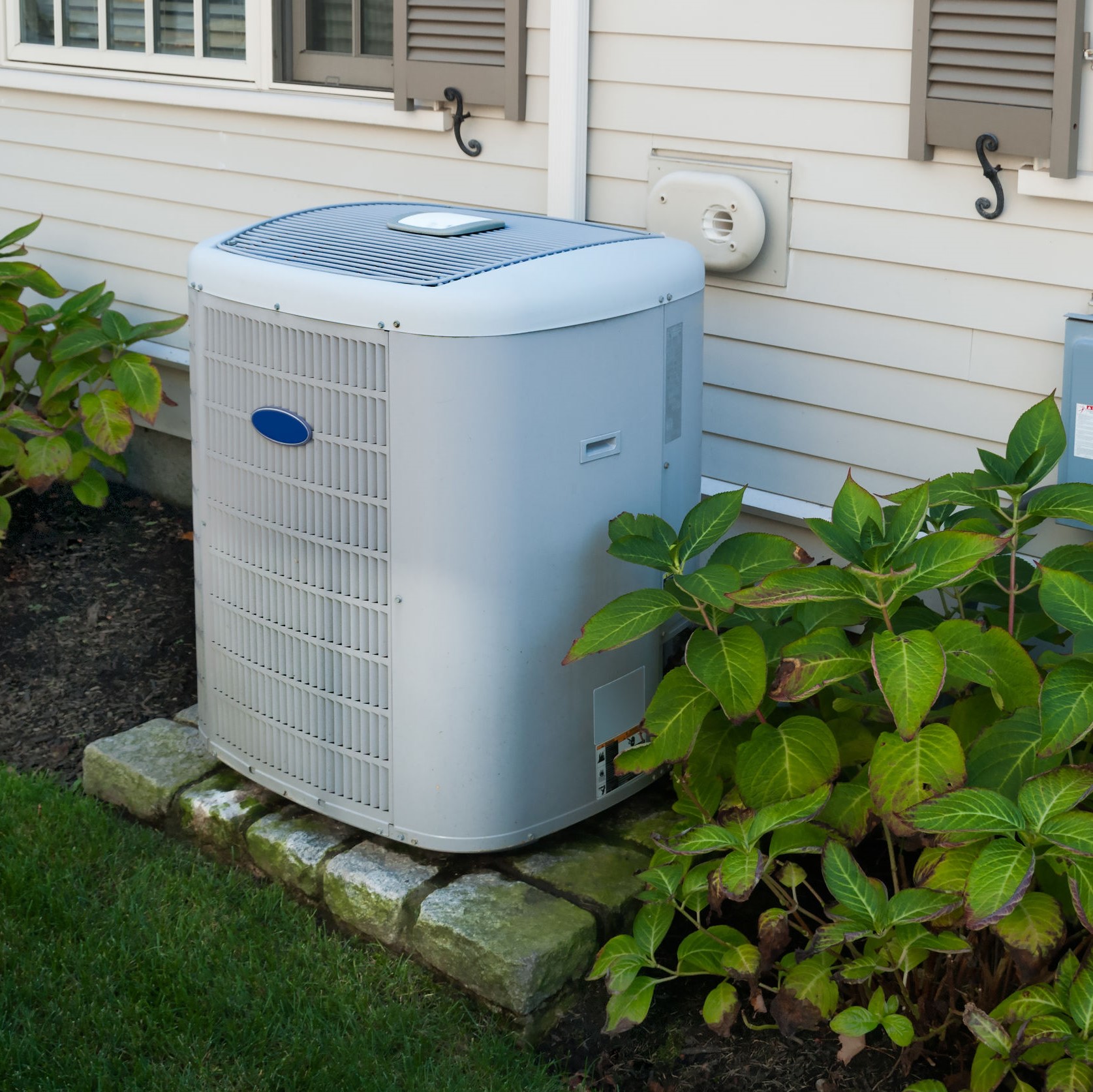 A new air conditioner sitting outside a home.